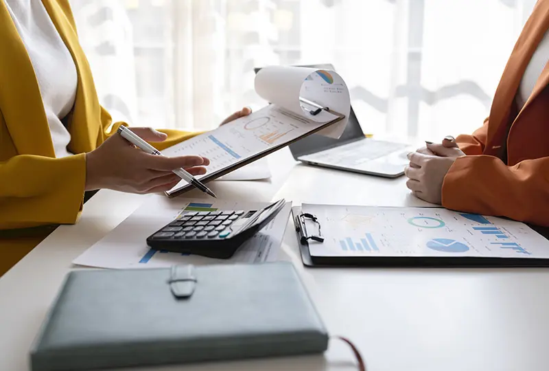 Business meeting with documents and calculators.