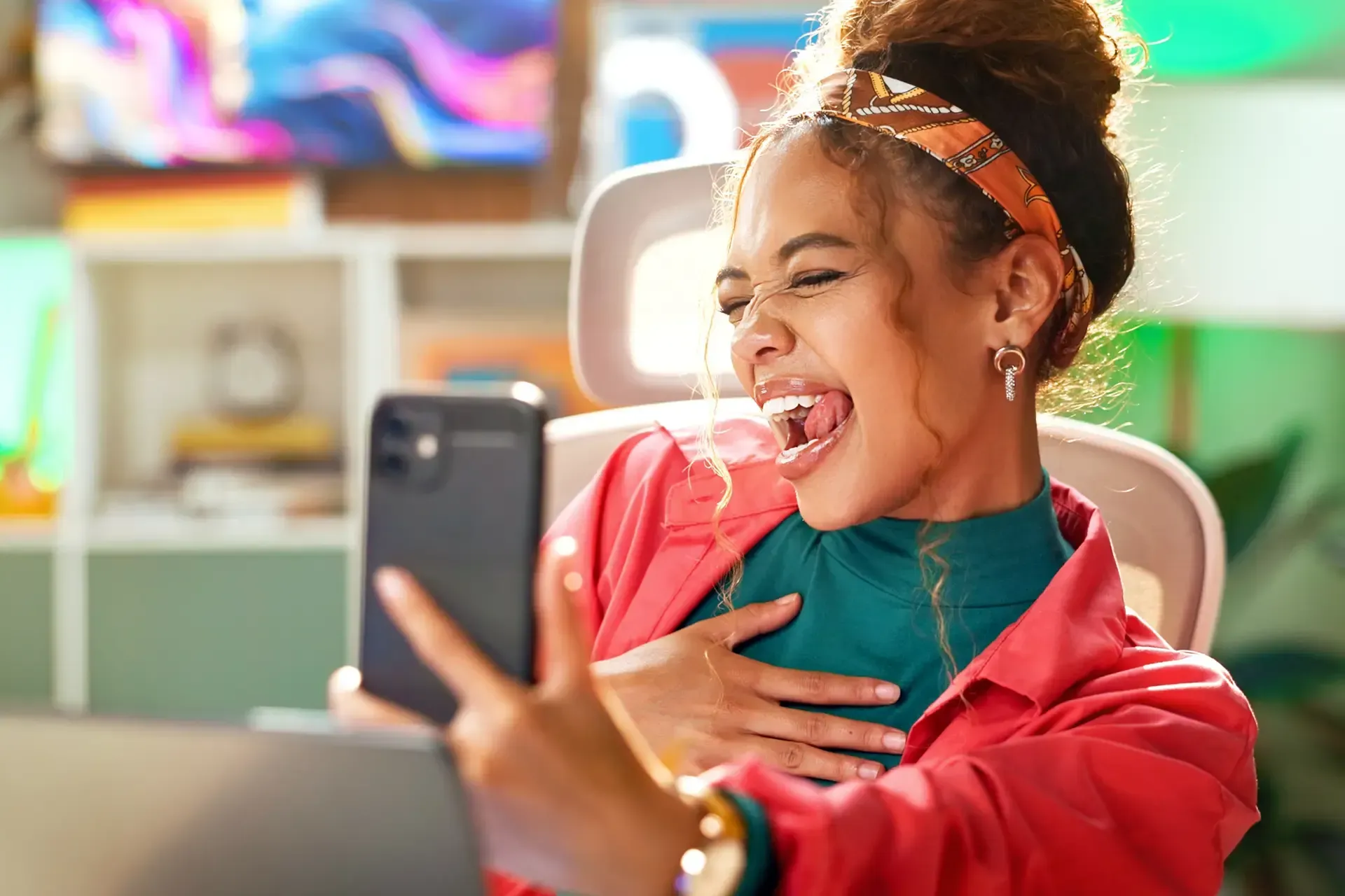 Woman taking a joyful selfie with smartphone.